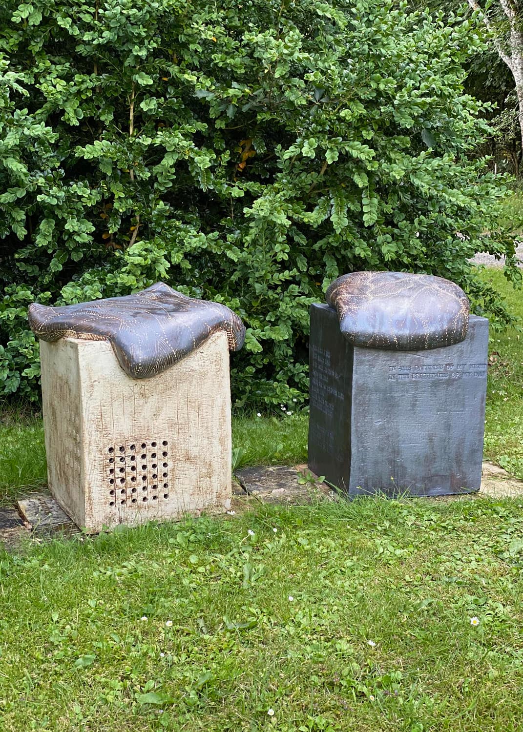 Two sculpture chairs on a lawn